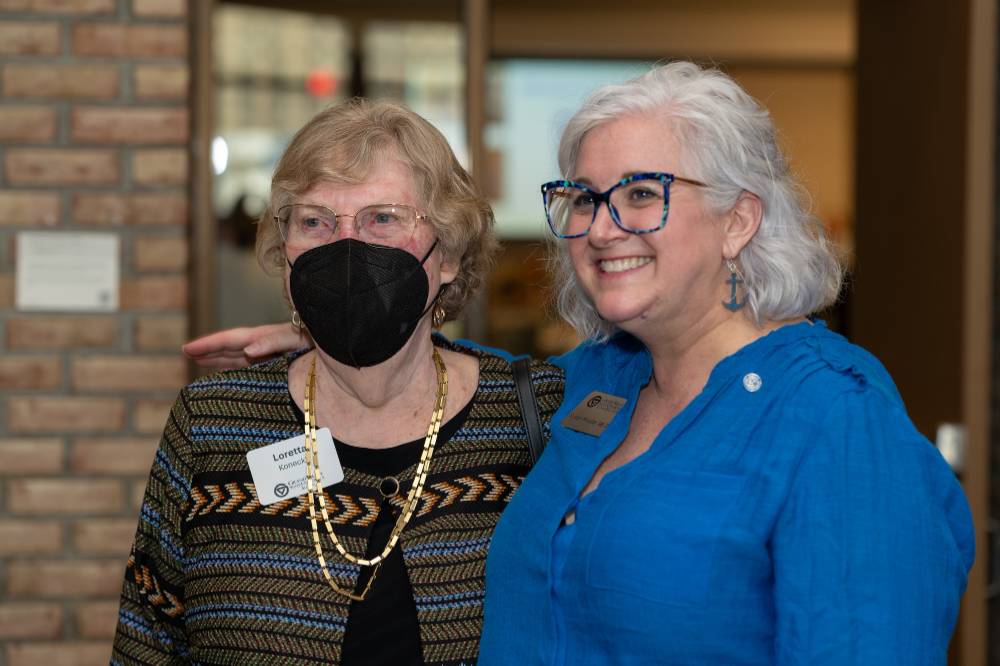 Susan Proctor poses for a photo with her arm around Loretta Konecki